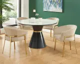 Un ensemble élégant : quatre chaises modernes en velours beige avec pieds dorés autour d'une table ancienne au design unique.