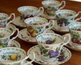 Service à thé en porcelaine anglaise, orné de fruits variés : citrons, prunes, raisins, cerises, poires, pamplemousses.