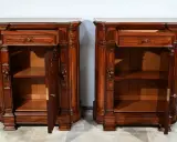 Paire de commodes en bois sombre, style mobilier Napoléon III, avec tiroirs et portes sculptées.