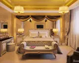 Chambre luxueuse aux accents dorés, évoquant un style empire. Un grand lit, une coiffeuse et des lampes ornées créent une atmosphère royale.