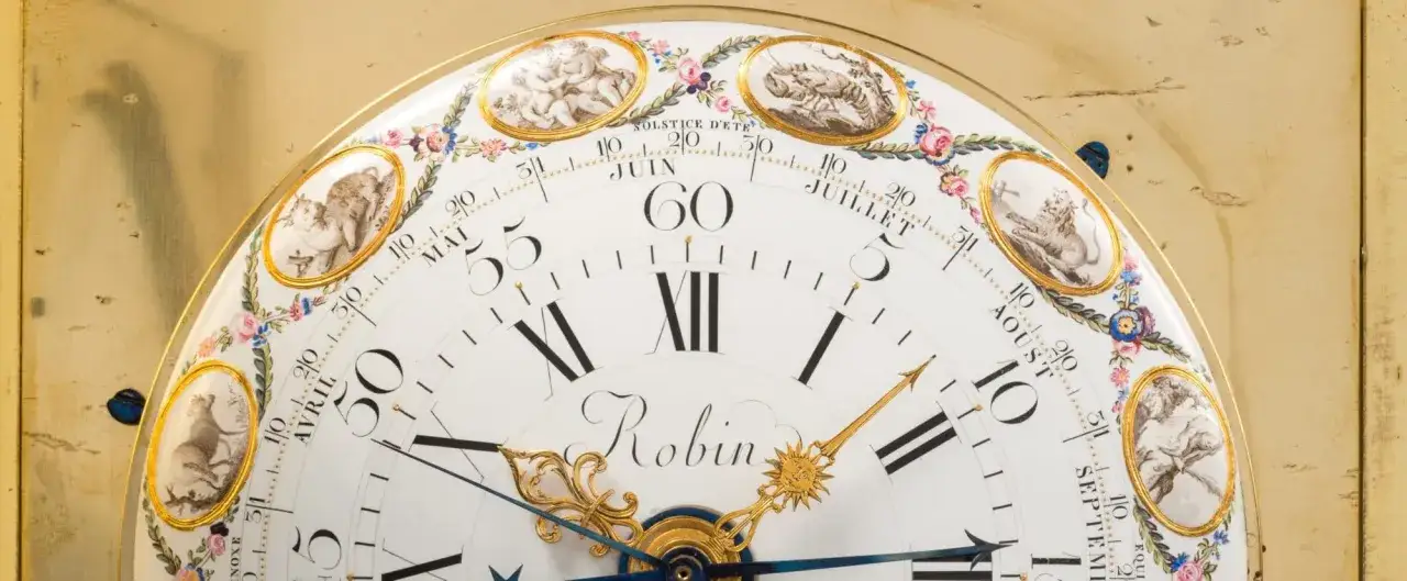 Cadran d'une horloge ancienne orn&eacute; de putti et de signes du zodiaque, avec le nom 